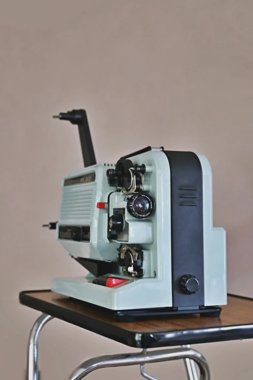 an antique film projector sits on a desk