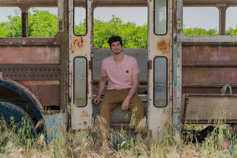 a man is sitting on an old bus