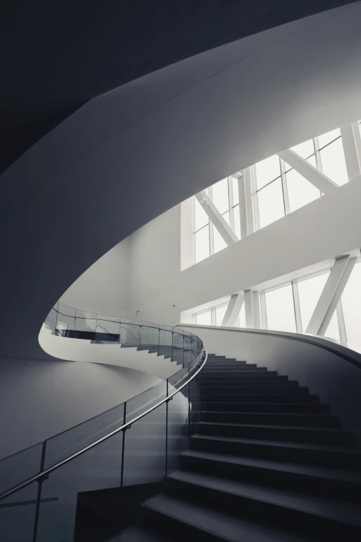 a white spiral stair rail in front of a bright window