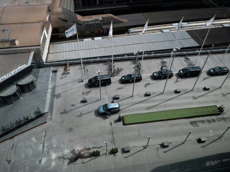 an aerial view of many cars parked outside