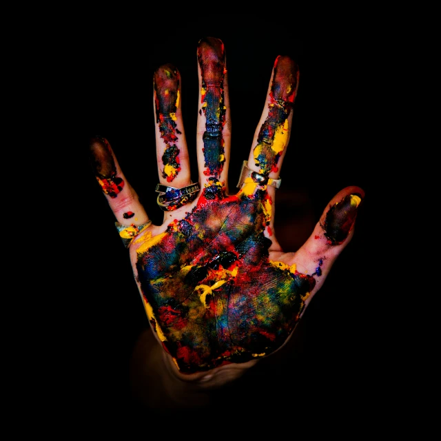 a picture of someones hand that has various colors on it