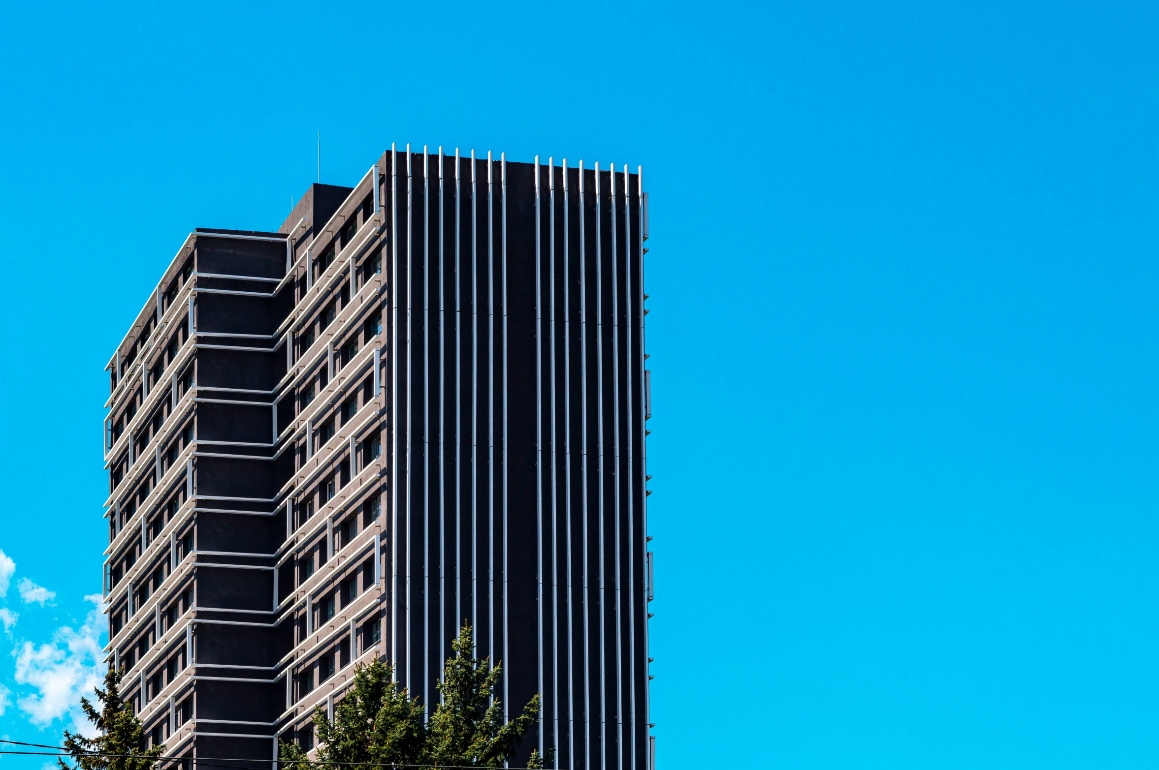 an office building in the city against a clear blue sky