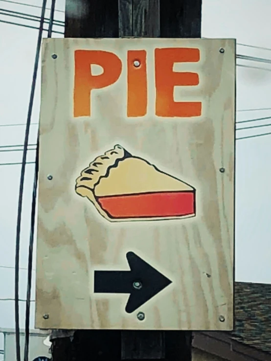 a wooden sign that has a pie in it