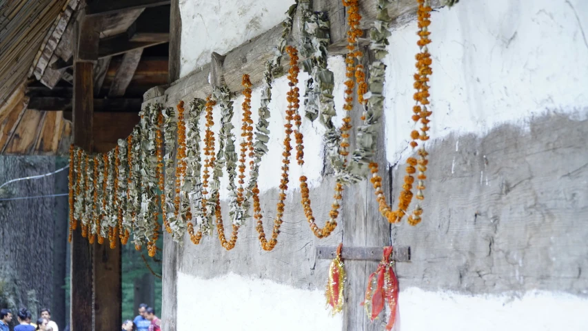 many beads are hung on the ceiling in front of an asian building