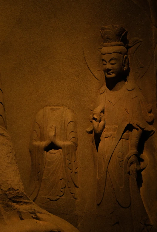 a carved stone statue on display in a museum