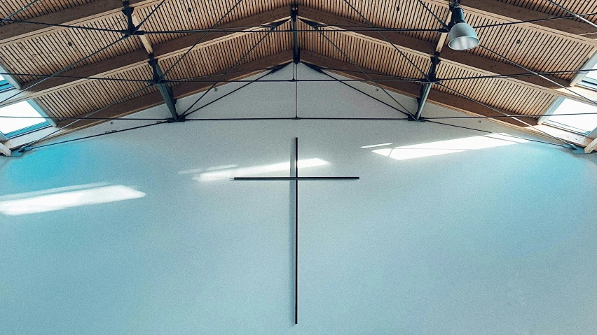 large indoor church with wooden cross on roof