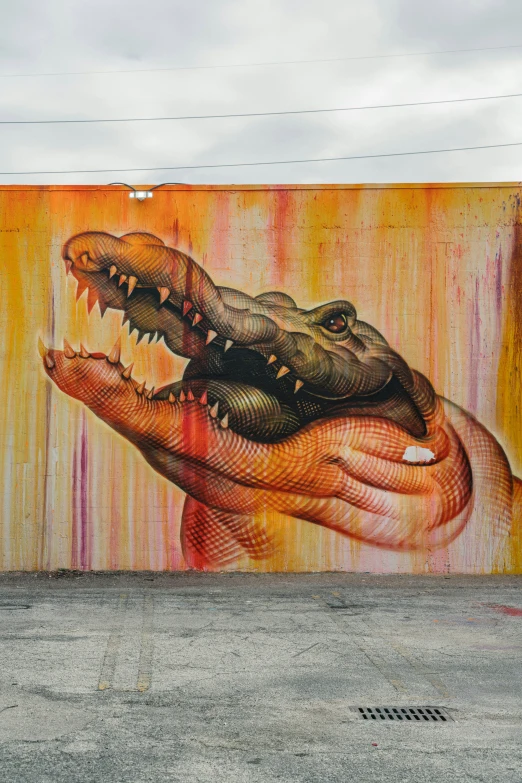 there is a painting on the wall that shows an alligator biting another animal