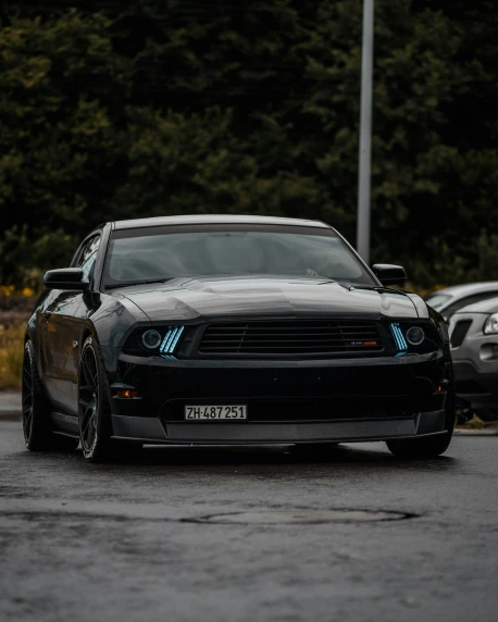a mustang car that is in the parking lot