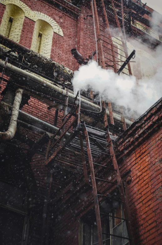 smoke coming out of the pipes of an old building