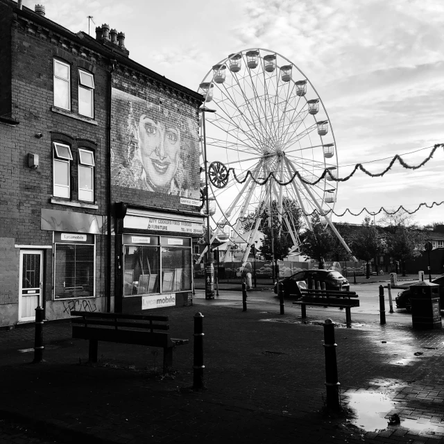 a view of an outdoor entertainment area with a large ferris wheel