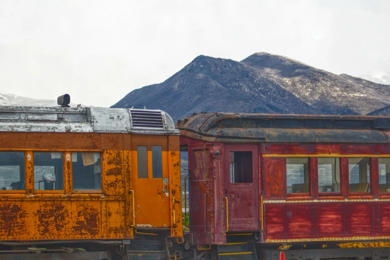 some old train cars that are sitting in the dirt