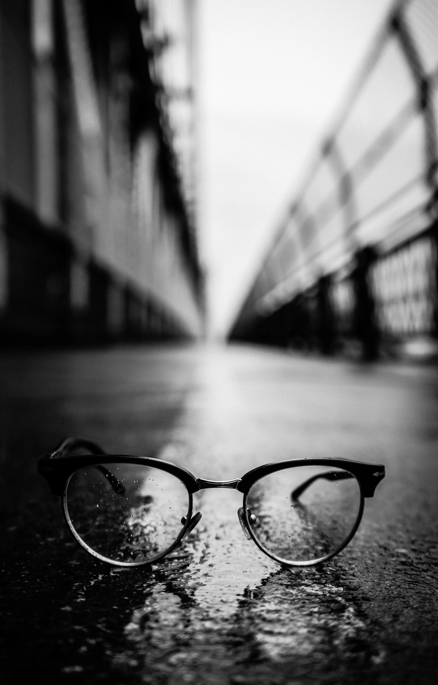 glasses laying on the ground with a curtain in the background