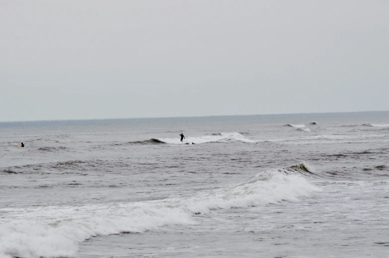 a person surfing on a surf board and others in the ocean