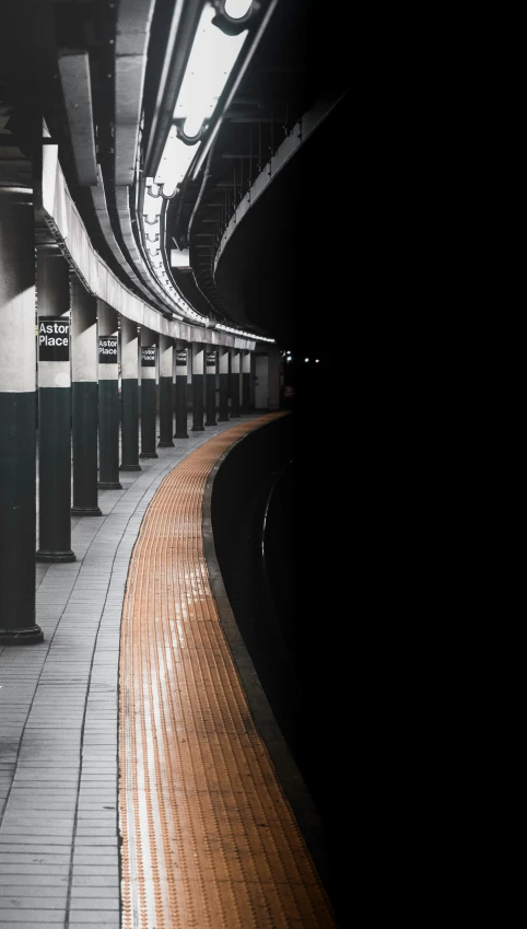 a subway station with empty stalls on one side