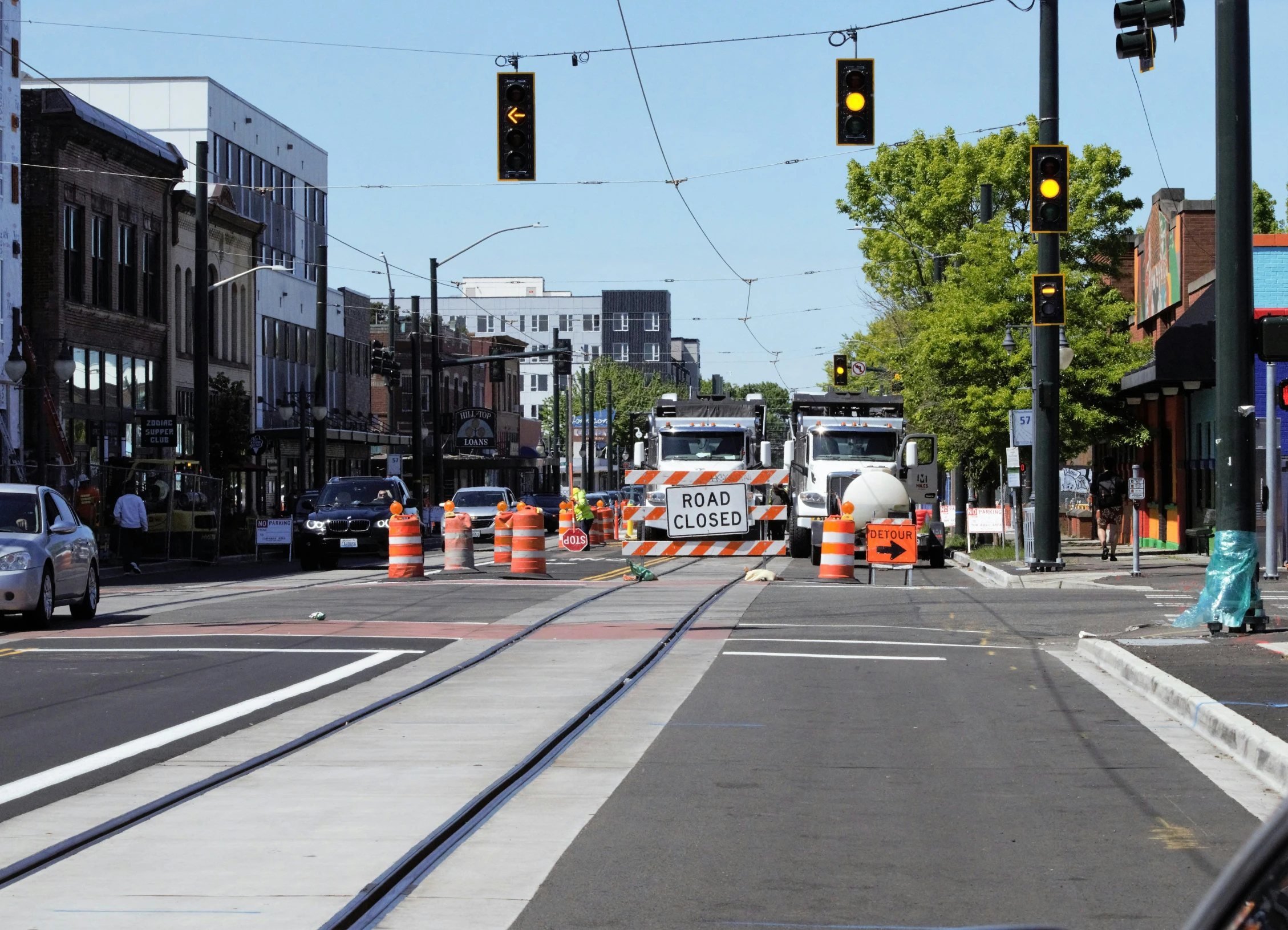 an intersection with a construction crew standing at the side of the road