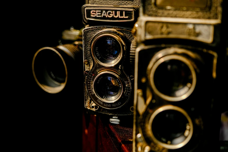 two antique cameras sitting side by side
