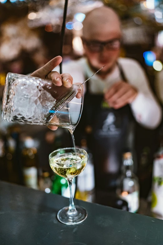 a man pouring white liquid into a glass