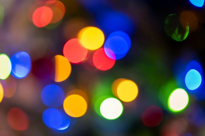 blurry image of many multicolored lights, including blue
