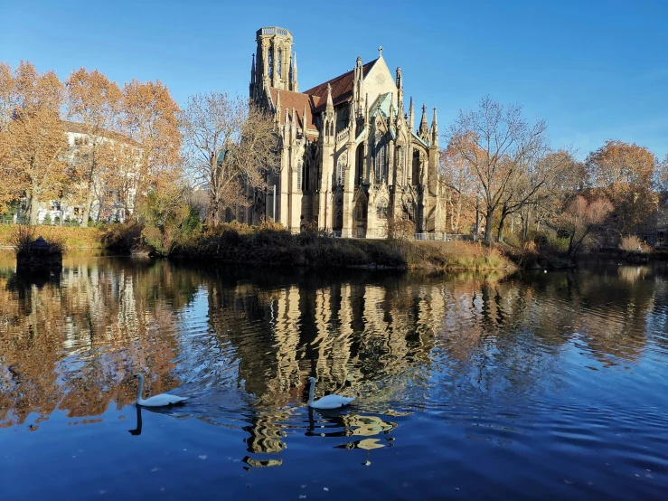 the cathedral is standing on an island in a park