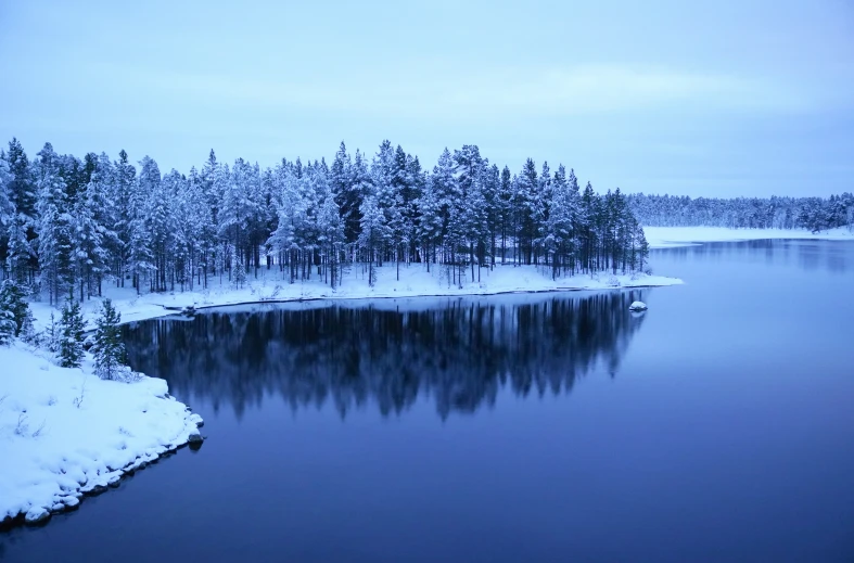 some deep blue water with snow on the ground