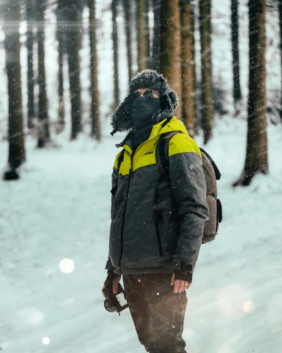 a man with skis and gear standing in the snow