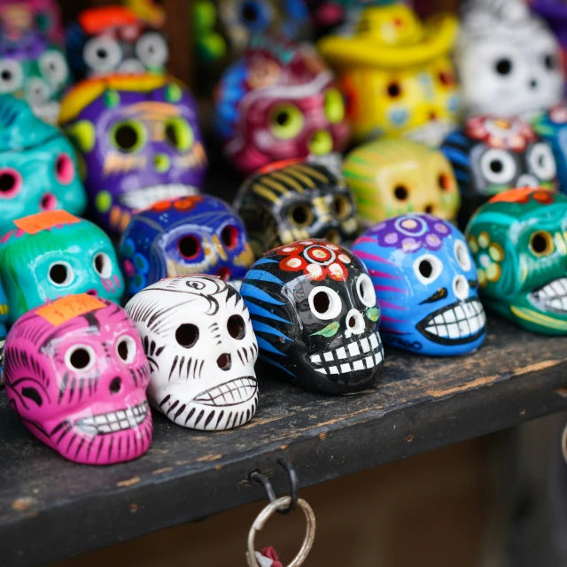 brightly colored sugar skulls sit on display in a shop