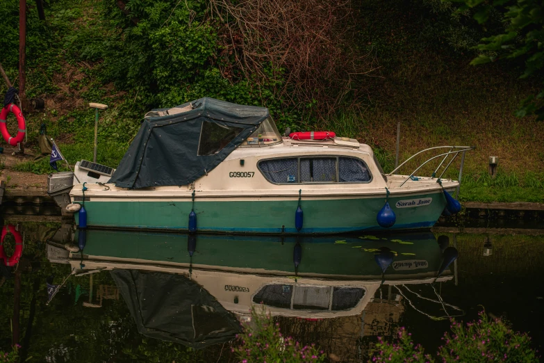 a boat sitting next to some docks next to some water