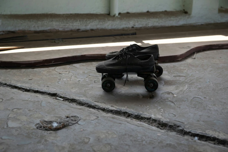 a worn out shoe sitting on top of a skateboard