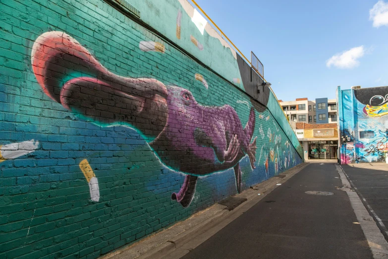 a wall with colorful painting of a large bird