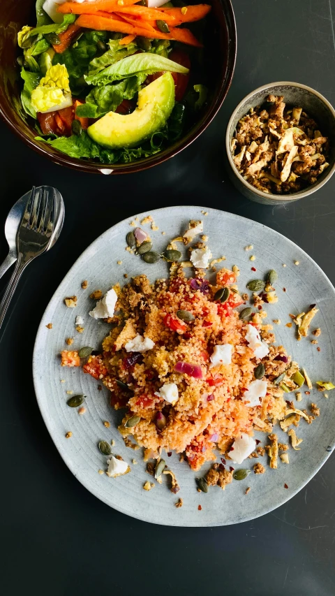 a plate of food with vegetables sitting in the background