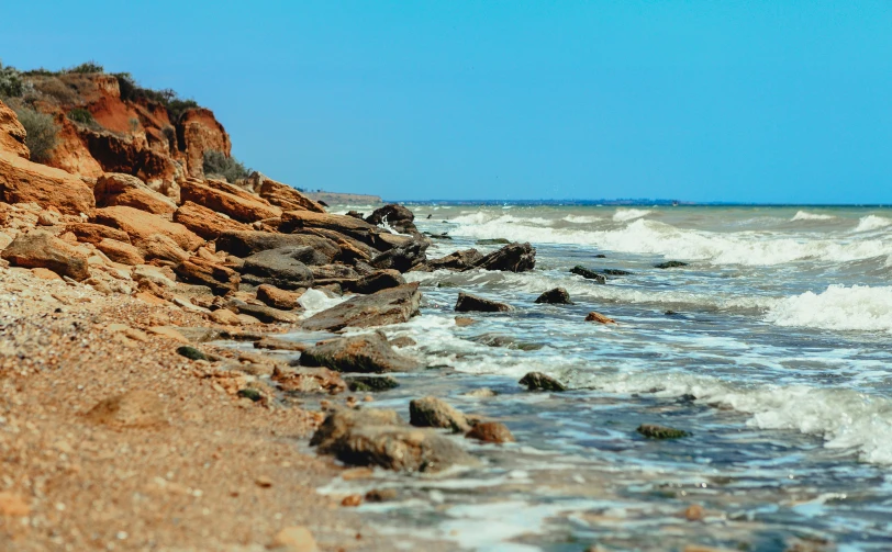 waves on the rocky beach and rocks by the water