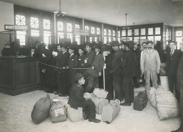 a crowd of people that are standing around luggage