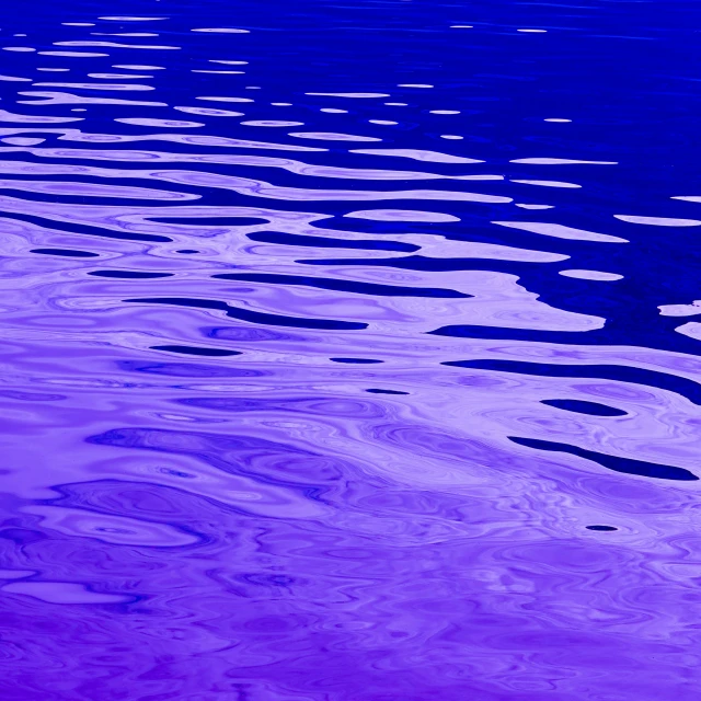 water is purple and white with lots of small clouds