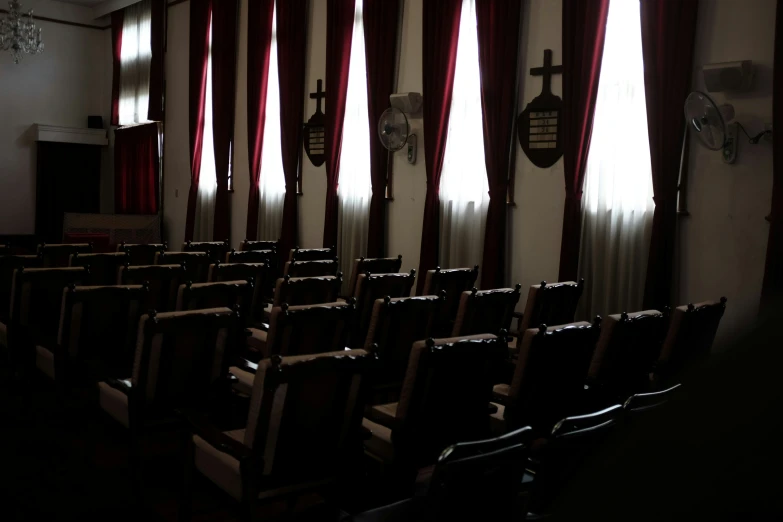 there is a row of empty chairs in front of a stage