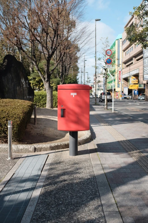 a mail box is sitting on the side of the street