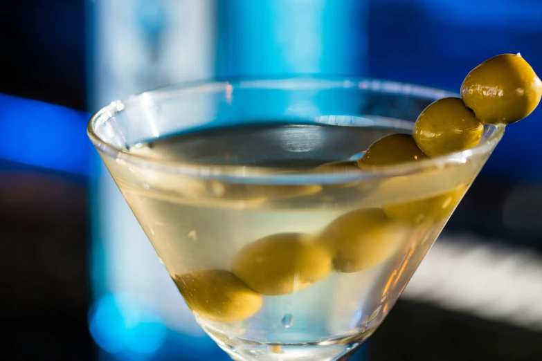 the martini has olives on the rim