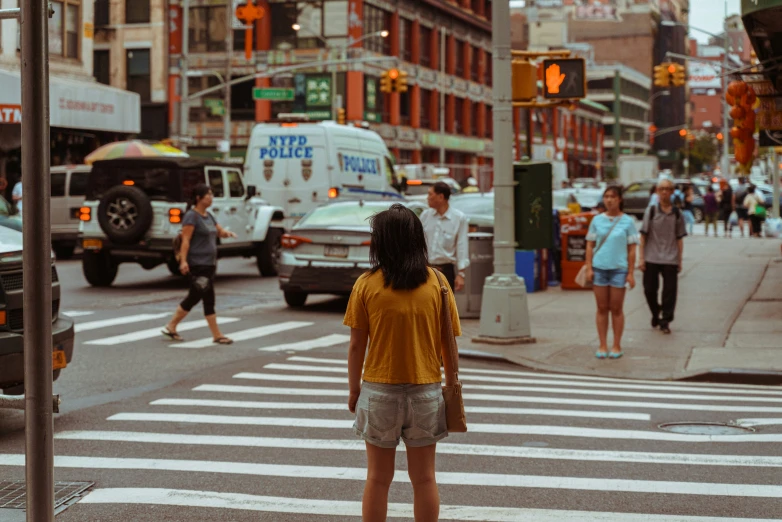 a group of people cross a city street