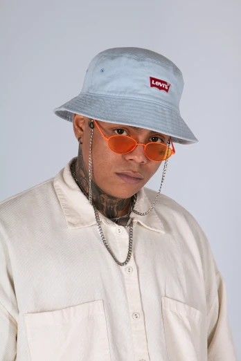a man with tattoos and a hat standing