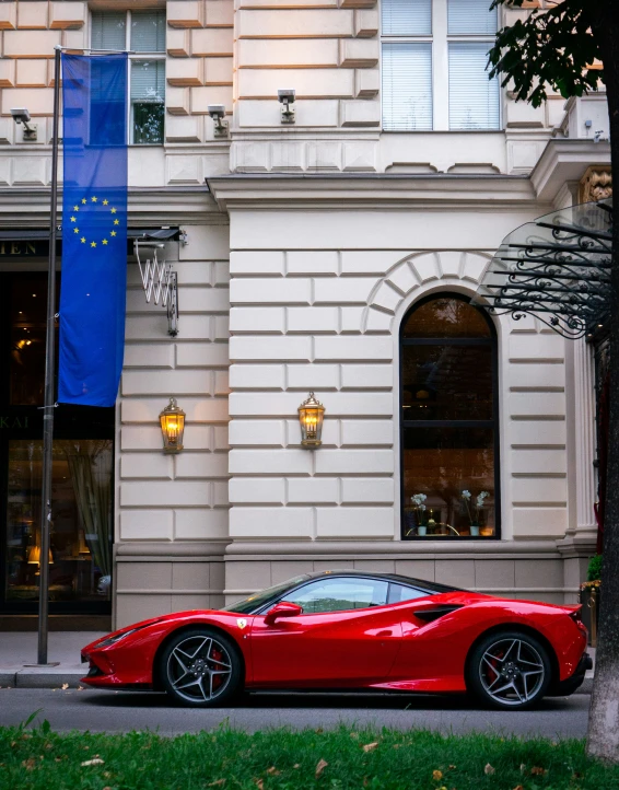 a red sports car parked next to a building