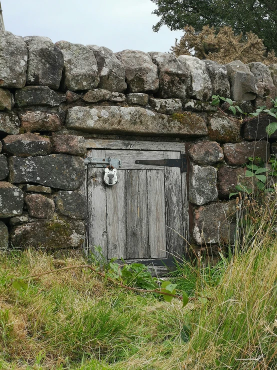 an open door is seen inside a stone wall