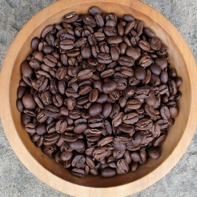 a bowl filled with coffee beans on a table