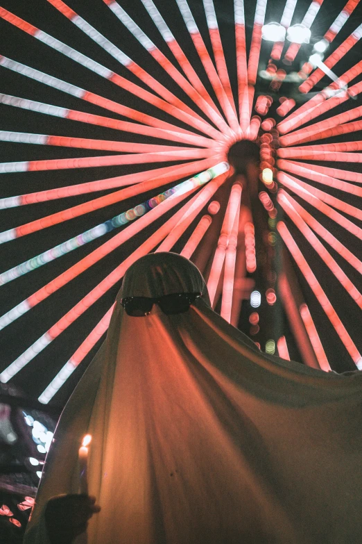 a large wheel with lots of colorful lights behind it