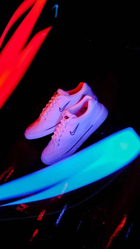 a pair of sneakers is seen through some glow sticks