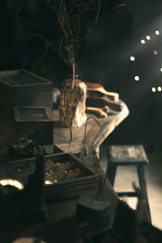 a wooden bench topped with lots of boxes under a light