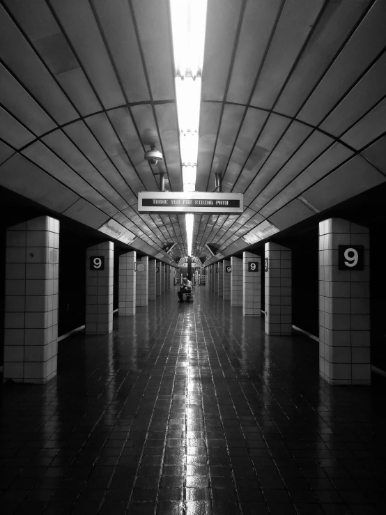 a black and white po of an empty subway station