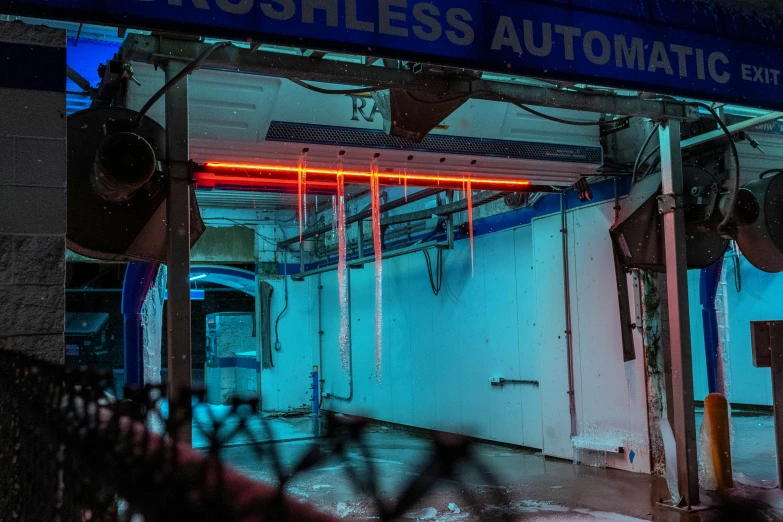 an old abandoned store front with neon lights in the window