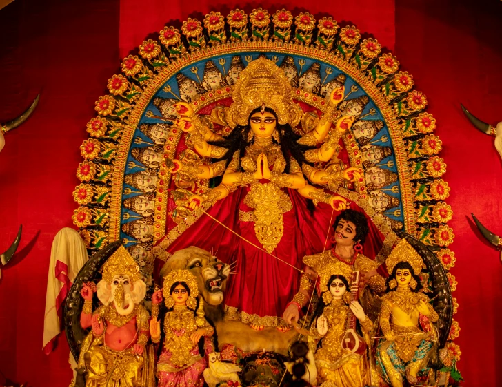 the statues of goddesses and deities displayed on the wall