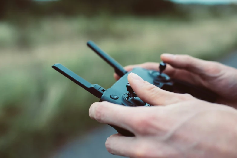 someone is holding onto their black plastic toy plane