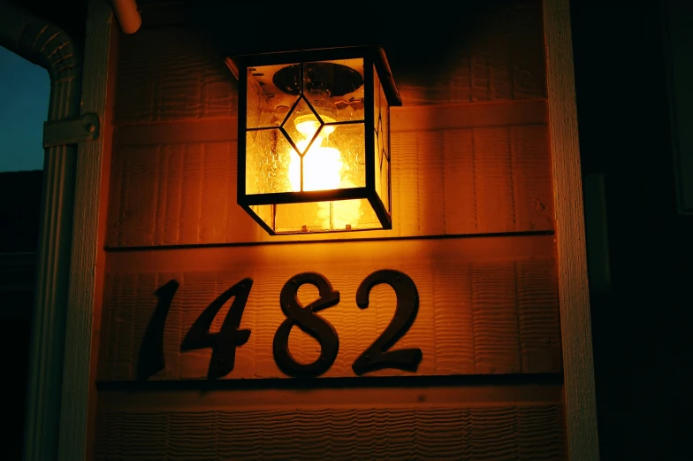 a lamp is illuminated on the front porch of a house