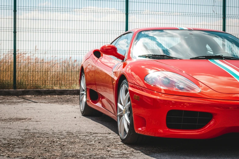 a red sports car is sitting in the lot